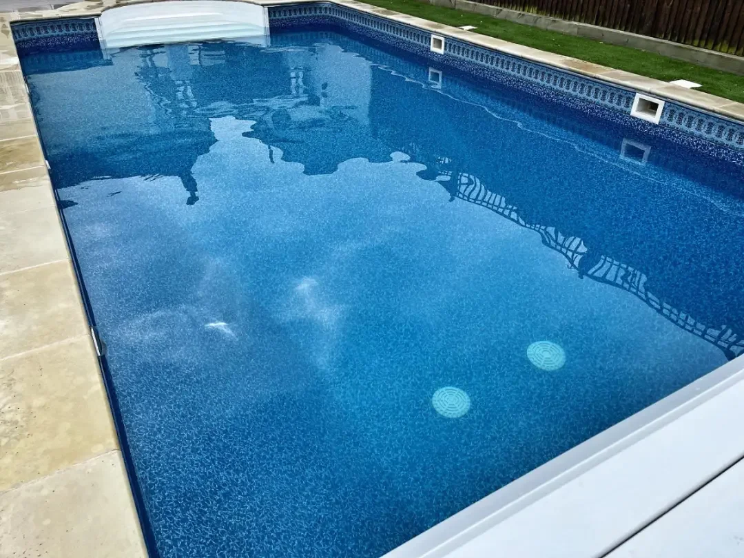 Back garden swimming pool with blue tiles