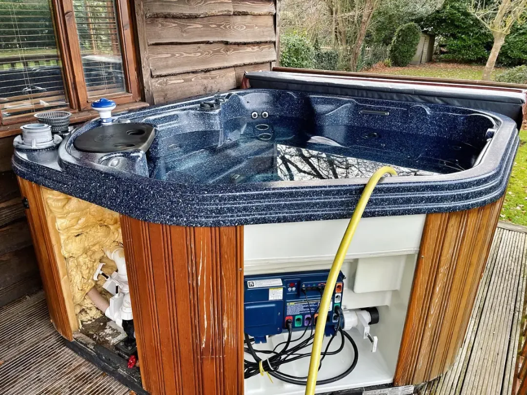 Hot tub with exterior panels removed for maintenance